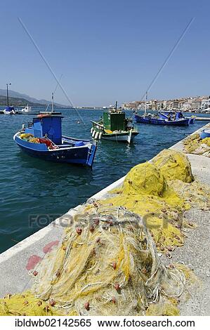 Fishing boats in the fishing port at the Themistokli Sofouli street, Samos city, Samos island, southern Sporades, Aegean sea, Greece, Europe View Large Photo Image Stock Photography - Fishing boats in the fishing port at the Themistokli Sofouli street, Samos city, Samos island, southern Sporades, Aegean sea, Greece, Europe. Fotosearch