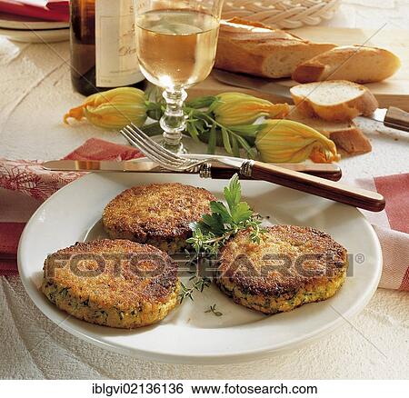 Stock Photograph - French zucchini patties, grated zucchini with white bread, egg, cheese and vegetables, France, Europe. Fotosearch