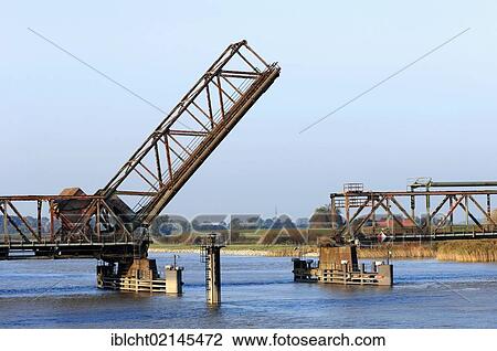 Stock Image - Friesenbruecke bridge when opened, a railway bascule bridge crossing the Ems River, Weener, East Frisia, Lower Saxony, Germany, Europe. Fotosearch