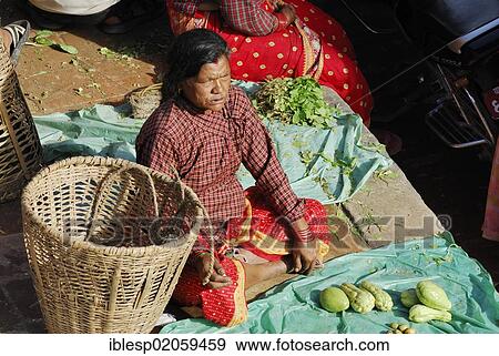 Stock Photo - Fruit and vegetable vendor on the Taumadhi square, Bhaktapur, Kathmandu Valley, Nepal, Asia. Fotosearch