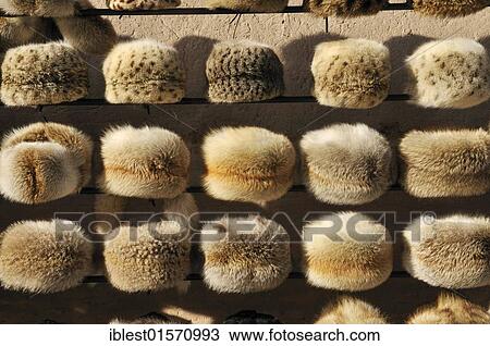 Stock Image - Fur hat for sale, historic adobe town of Khiva, Ichan Kala, Chiva, Unesco World Heritage Site, Uzbekistan, Central Asia, Asia. Fotosearch