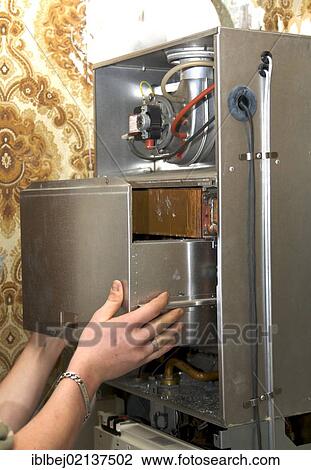 Stock Image - Gas boiler maintenance. Fotosearch