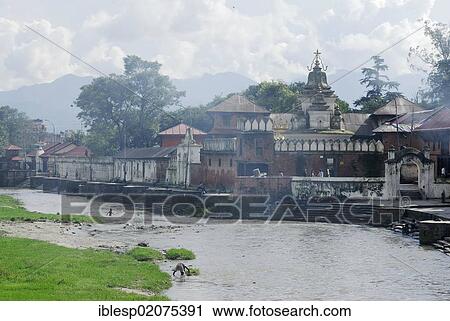 Stock Image - Ghats of Pashupatinath on the sacred Bagmati River, Kathmandu, Nepal, Asia. Fotosearch