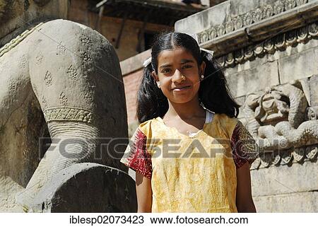 Stock Image - Girl at Nyatapola Temple, Taumadhi Square, Bhaktapur, Kathmandu Valley, Nepal, Asia. Fotosearch