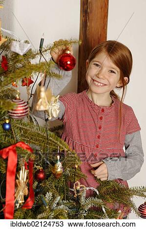 Girl with a Christmas tree View Large Photo Image Stock Image - Girl with a Christmas tree. Fotosearch