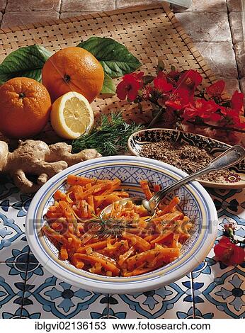 Stock Image - Glazed carrots, steamed with ginger and orange peel in white wine with vegetables, Morocco, Africa. Fotosearch