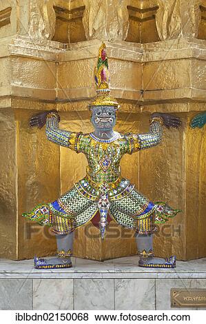 Stock Photo - Guardian statue on the base of a golden chedi at Wat Phra Kaeo, Wat Phra Kaew, the Royal Grand Palace, Bangkok, Thailand, Asia. Fotosearch