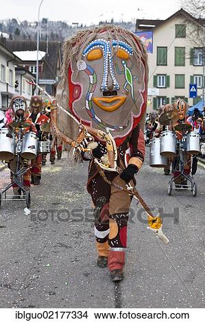 Picture - Guggen music band, drum major dressed up as indigenous Australian, Aborigine, 35th Motteri-Umzug parade in Malters, Lucerne, Switzerland, Europe. Fotosearch