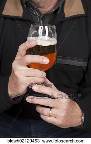 Hands holding glass of beer View Large Photo Image Stock Image - Hands holding glass of beer. Fotosearch