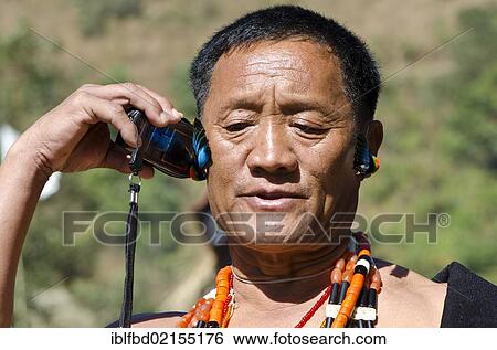 Headhunter using a mobile phone, Kohima, Nagaland, India, Asia View Large Photo Image Stock Photograph - Headhunter using a mobile phone, Kohima, Nagaland, India, Asia. Fotosearch