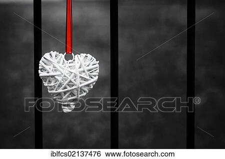 Heart with ribbon between iron bars View Large Photo Image Stock Photograph - Heart with ribbon between iron bars. Fotosearch