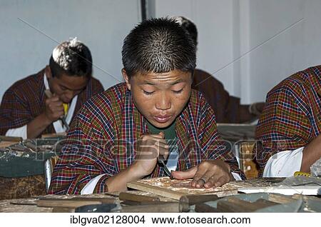 Highly concentrated students doing an apprenticeship in woodcarving at the National Institute of Traditional Arts and Crafts, Zorig Chusum, Thimphu, Bhutan, Asia View Large Photo Image Picture - Highly concentrated students doing an apprenticeship in woodcarving at the National Institute of Traditional Arts and Crafts, Zorig Chusum, Thimphu, Bhutan, Asia. Fotosearch