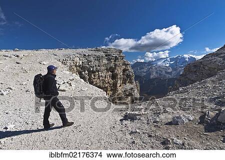 Hiker enjoying the view from Sass Pordoi, Sella-Group, Sella Ronda, Dolomites, Italy, Europe View Large Photo Image Picture - Hiker enjoying the view from Sass Pordoi, Sella-Group, Sella Ronda, Dolomites, Italy, Europe. Fotosearch