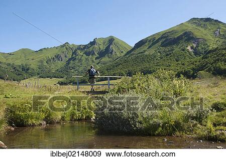 Hiker in the valley of Salt Fountains, Massif of Sancy, Puy de Dome, Auvergne, France, Europe View Large Photo Image Stock Photo - Hiker in the valley of Salt Fountains, Massif of Sancy, Puy de Dome, Auvergne, France, Europe. Fotosearch