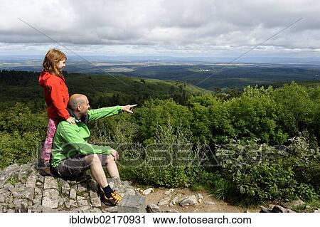 Stock Image - Hikers on the rocks of Koenigsstuhl, Donnersberg Mountain, highest peak of the Palatinate, North Palatine, Rhineland-Palatinate, Germany, Europe. Fotosearch