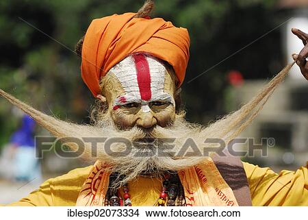 Holy man, Sadhu, with a painted face and a long beard, Pashupatinath on the sacred Bagmati River, Kathmandu, Nepal, Asia View Large Photo Image Picture - Holy man, Sadhu, with a painted face and a long beard, Pashupatinath on the sacred Bagmati River, Kathmandu, Nepal, Asia. Fotosearch