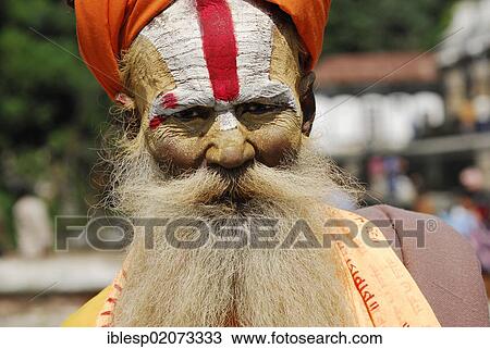 Holy man, Sadhu, with a painted face and a long beard, Pashupatinath on the sacred Bagmati River, Kathmandu, Nepal, Asia View Large Photo Image Stock Image - Holy man, Sadhu, with a painted face and a long beard, Pashupatinath on the sacred Bagmati River, Kathmandu, Nepal, Asia. Fotosearch