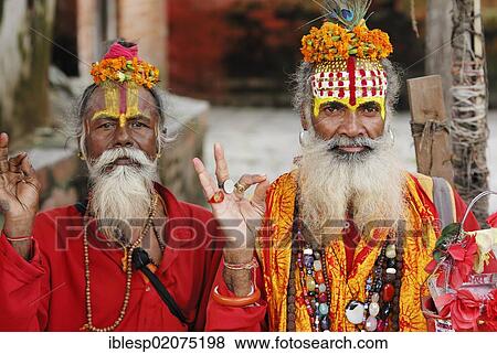Stock Photo - Holy men, Sadhus, with painted faces and long beards, Durbar Square, Kathmandu, Nepal, Asia. Fotosearch