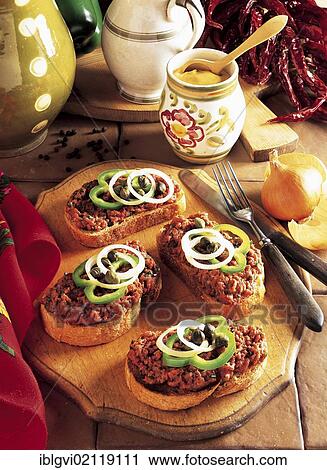 Stock Image - Hungarian steak tartare with bread, minced beef filet, spicy seasoning, served on bread, cold starter, Hungary, Europe. Fotosearch
