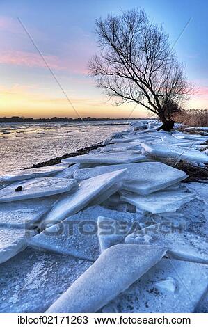 Stock Image - Ice on the banks of the Elbe river in winter, Kirchwerder, Vier- und Marschlande landscape, Hamburg, Germany, Europe. Fotosearch