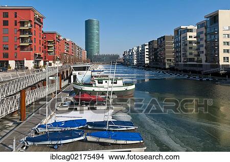 Picture - Ice on the Main River in Frankfurt's West Harbour, looking towards Westhafen Tower, nicknamed Apple Wine Tower after the shape of a typical Frankfurtian cider glass, Frankfurt am Main, Hesse, Germany, Europe. Fotosearch