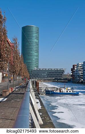Stock Image - Ice on the Main River in Frankfurt's West Harbour, looking towards Westhafen Tower, nicknamed Apple Wine Tower after the shape of a typical Frankfurtian cider glass, Frankfurt am Main, Hesse, Germany, Europe. Fotosearch