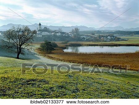 Iffeldorf with Lake Sengsee in front of the Estergebirge and Wetterstein mountain ranges with Zugspitze Mountain, Upper Bavaria, Germany, Europe View Large Photo Image Stock Photo - Iffeldorf with Lake Sengsee in front of the Estergebirge and Wetterstein mountain ranges with Zugspitze Mountain, Upper Bavaria, Germany, Europe. Fotosearch