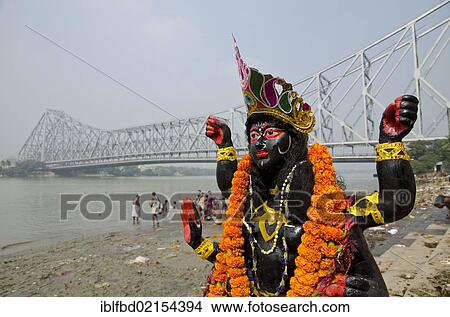 Kali statue at the banks of river Hooghly, Howrah Bridge at back, Kolkata, West Bengal, India, Asia View Large Photo Image Picture - Kali statue at the banks of river Hooghly, Howrah Bridge at back, Kolkata, West Bengal, India, Asia. Fotosearch