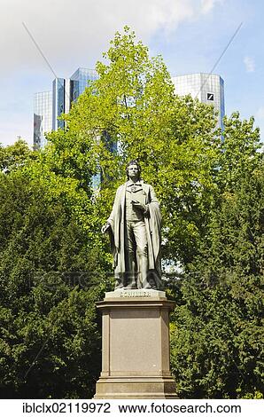 Stock Image - Land der Dichter und Banker statue, literally land of poets and bankers, Schiller monument in front of the headquarters of Deutsche Bank, Fankfurt, Hesse, Germany, Europe. Fotosearch