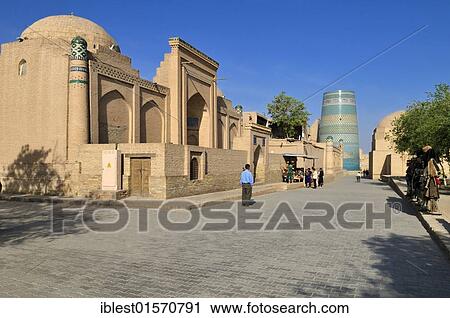 Stock Image - Lane in the historic Ichan Kala historic adobe town of Khiva, Chiva with Kalta Minor minaret, Silk Road, Unesco World Heritage Site, Uzbekistan, Central Asia, Asia. Fotosearch