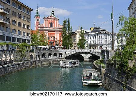 Stock Photo - Ljublijanica or Ljubljanica river with the Franciscan Church at back, Ljublijana, Slovenia, Europe. Fotosearch