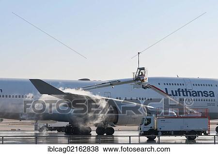 Stock Photo - Lufthansa Boeing 747-430M being de-iced at Frankfurt Airport, Hesse, Germany, Europe, PublicGround, Europe. Fotosearch