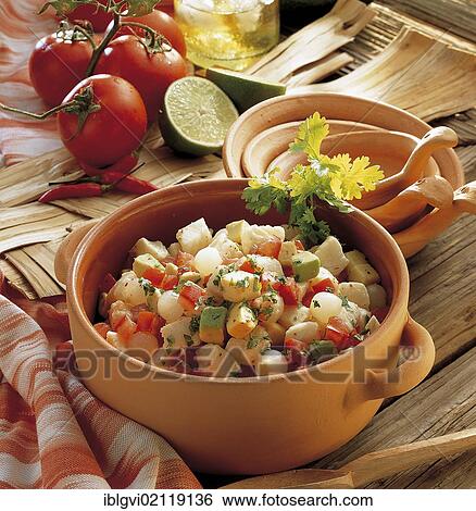 Stock Photograph - Marinated halibut cubes with tomatoes and avocado, cold starter, Mexico, North America. Fotosearch