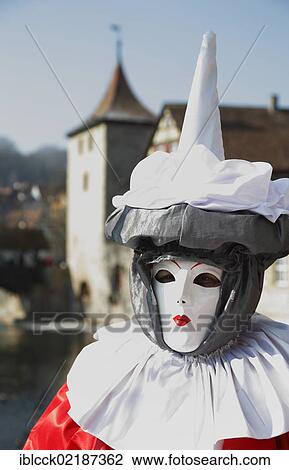 Stock Image - Mask, Sulfertor gate and the banks of the Kocher River at the back, Hallia Venezia carnival, Schwaebisch Hall, Baden-Wuerttemberg, Germany, Europe. Fotosearch