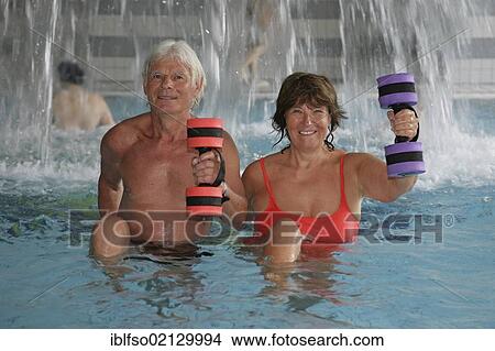 Mature couple doing senior sport in the Roland Matthes swimming hall in Erfurt, Thuringia, Germany, Europe View Large Photo Image Picture - Mature couple doing senior sport in the Roland Matthes swimming hall in Erfurt, Thuringia, Germany, Europe. Fotosearch