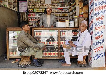 Men sitting in front of a shop, Kathmandu, Nepal, Asia View Large Photo Image Stock Photo - Men sitting in front of a shop, Kathmandu, Nepal, Asia. Fotosearch