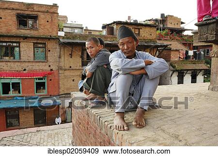 Men sitting on a wall, Nyatapola Pagoda, Taudadhi Square, Bhaktapur, Kathmandu Valley, Nepal, Asia View Large Photo Image Stock Photo - Men sitting on a wall, Nyatapola Pagoda, Taudadhi Square, Bhaktapur, Kathmandu Valley, Nepal, Asia. Fotosearch