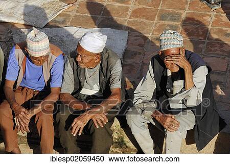 Men sitting on the Taumadhi Square, with traditional headwear, Bhaktapur, Kathmandu Valley, Nepal, Asia View Large Photo Image Stock Image - Men sitting on the Taumadhi Square, with traditional headwear, Bhaktapur, Kathmandu Valley, Nepal, Asia. Fotosearch