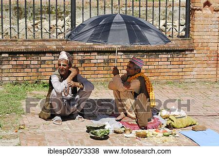 Men sitting under an umbrella, Kathmandu, Nepal, Asia View Large Photo Image Stock Photo - Men sitting under an umbrella, Kathmandu, Nepal, Asia. Fotosearch