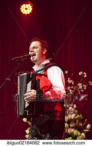 Stock Image - Michael Ringler, accordionist of the Austrian folk music and pop band "Die jungen Zillertaler" performing live at the Schlager Nacht 2012, pop music event, in Lucerne, Switzerland, Europe. Fotosearch