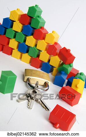 Stock Image - Miniature houses, padlock and keys, symbolic image real estate. Fotosearch