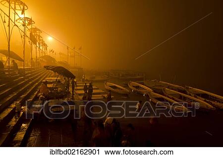 Stock Image - Morning fog over the ghats of Varanasi, Uttar Pradesh, India, Asia. Fotosearch