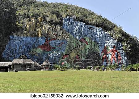 Stock Image - Mural de la Prehistoria, prehistoric wall, painted in 1961 by Mexican artist Leovigildo González Morillo, size 120x180 meters, Vinales, UNESCO World Heritage Site, Province of Pinar del Rio, Cuba, Greater Antilles, Caribbean, Central America, America,.... Fotosearch