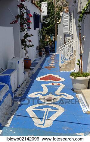 Stock Photograph - Narrow street in the port city of Pythagorio, Samos Island, Aegean Sea, southern Sporades islands, Greece, Europe. Fotosearch