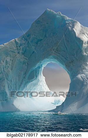 Stock Photo - Natural arch carved in an iceberg, Antarctic Sound, Antarctic Peninsula, Antarctica. Fotosearch
