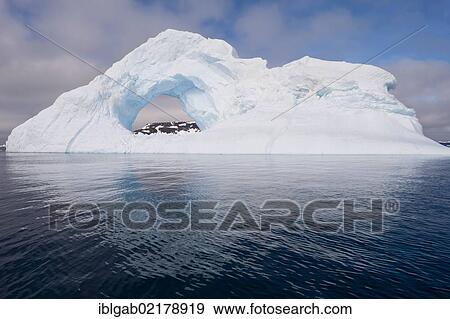 Stock Photo - Natural arch carved in an iceberg, Antarctic Sound, Antarctic Peninsula, Antarctica. Fotosearch