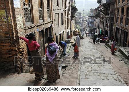 Nepalese people in traditional dress on historic street, Bhaktapur, Kathmandu Valley, Nepal, Asia View Large Photo Image Stock Photograph - Nepalese people in traditional dress on historic street, Bhaktapur, Kathmandu Valley, Nepal, Asia. Fotosearch