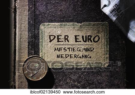 Stock Image - Old book with the inscription, Der Euro – Aufstieg und Niedergang, German for The euro – rise and fall, symbolic image for the euro crisis. Fotosearch
