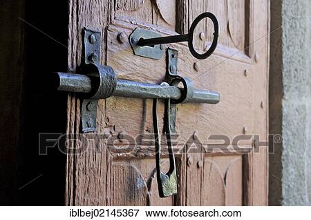 Stock Photo - Old door of wood with its worn lock, Church in Cantal, Auvergne, France, Europe. Fotosearch
