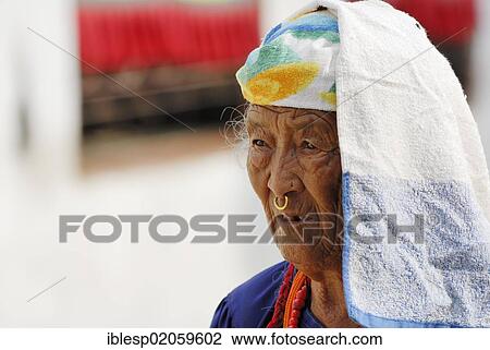 Stock Image - Old woman walking around stupa of Boudhanath, Kathmandu, Nepal, Asia. Fotosearch